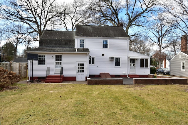 back of house featuring a shingled roof, a chimney, fence, an AC wall unit, and a yard