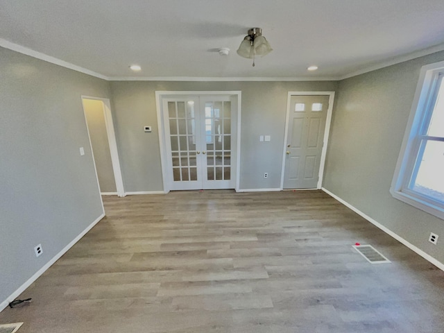 interior space with baseboards, visible vents, and french doors