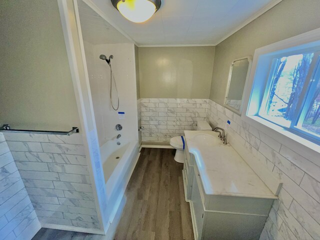39 Orchard St, Winchester, CT 06098 - full bathroom with tile walls, vanity, wood finished floors, toilet, and bathtub / shower combination