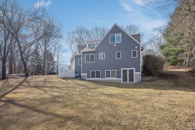 rear view of property with a lawn