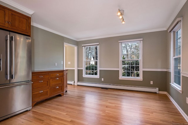 kitchen featuring a baseboard radiator, high end fridge, light wood-style floors, crown molding, and brown cabinets