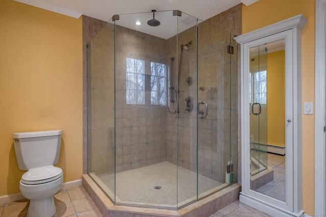 full bathroom with baseboards, toilet, a shower stall, and tile patterned flooring