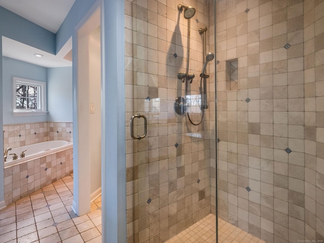 bathroom with tile patterned floors, a stall shower, and a garden tub