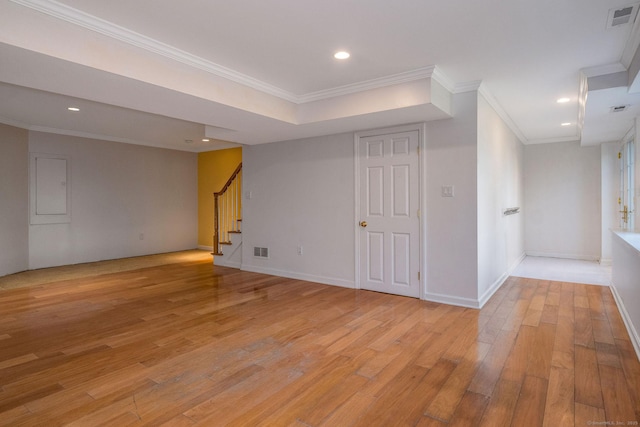 below grade area with stairs, light wood-style floors, and visible vents