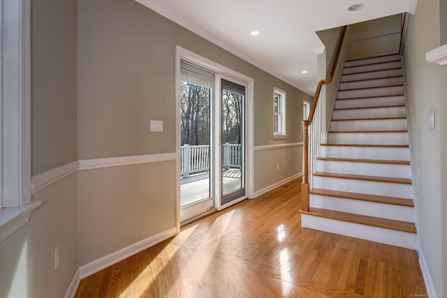 stairway with recessed lighting, crown molding, baseboards, and wood finished floors