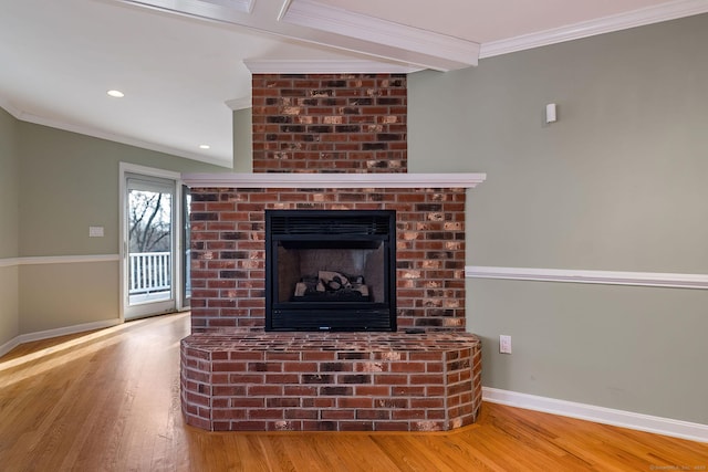 room details with a brick fireplace, crown molding, baseboards, recessed lighting, and wood finished floors