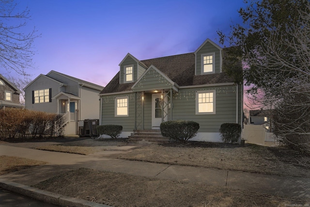 cape cod home with a shingled roof