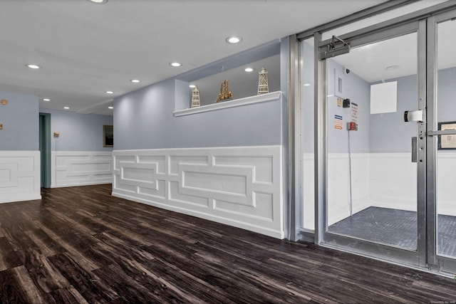 interior space with recessed lighting, wood finished floors, and wainscoting