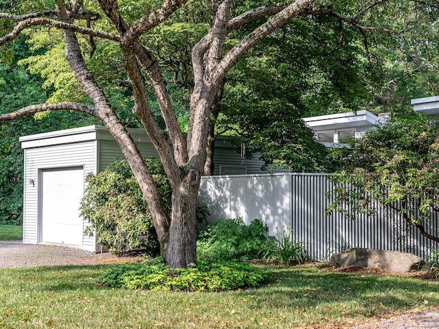 view of yard with a garage and fence