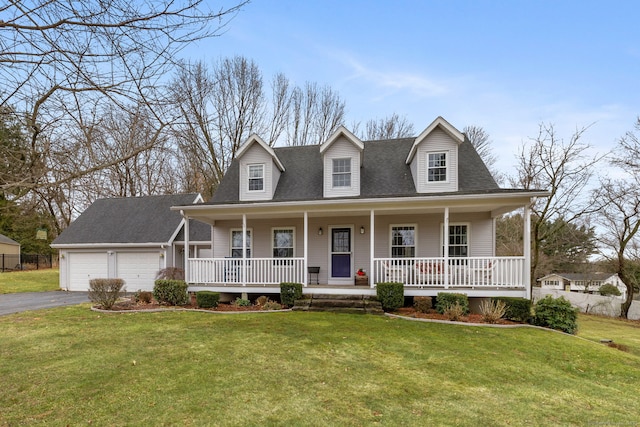 view of front facade featuring a porch, an attached garage, a front lawn, and driveway