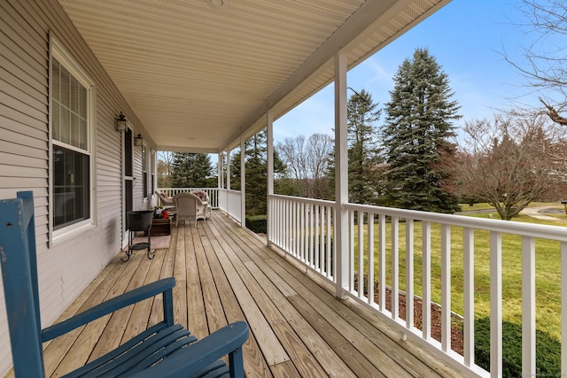 wooden deck with a lawn