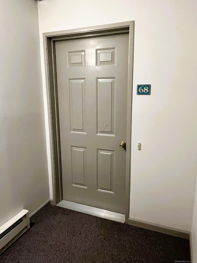 entrance to property featuring baseboard heating