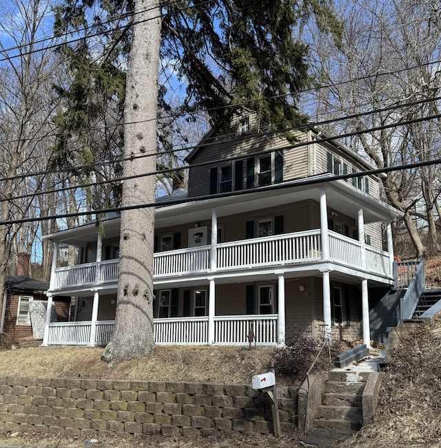 view of front facade with a porch and stairway