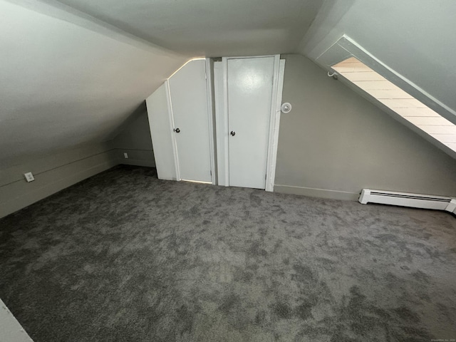 bonus room with vaulted ceiling, a baseboard radiator, and carpet flooring