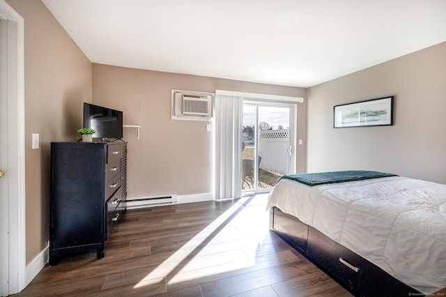 bedroom with baseboards, a baseboard radiator, dark wood-style flooring, access to exterior, and a wall mounted air conditioner