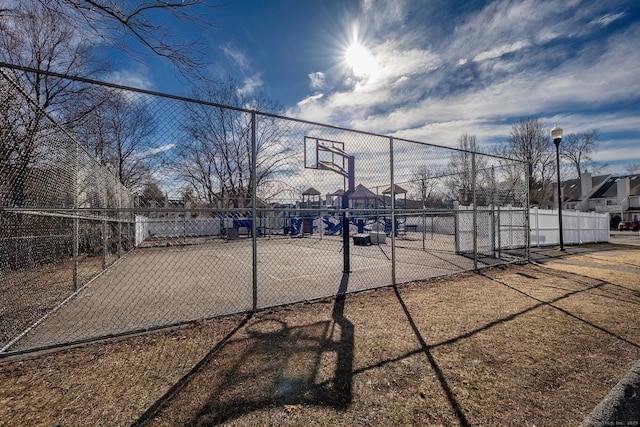 view of basketball court with community basketball court and fence