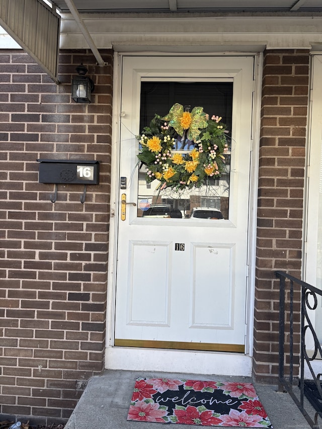 property entrance with brick siding