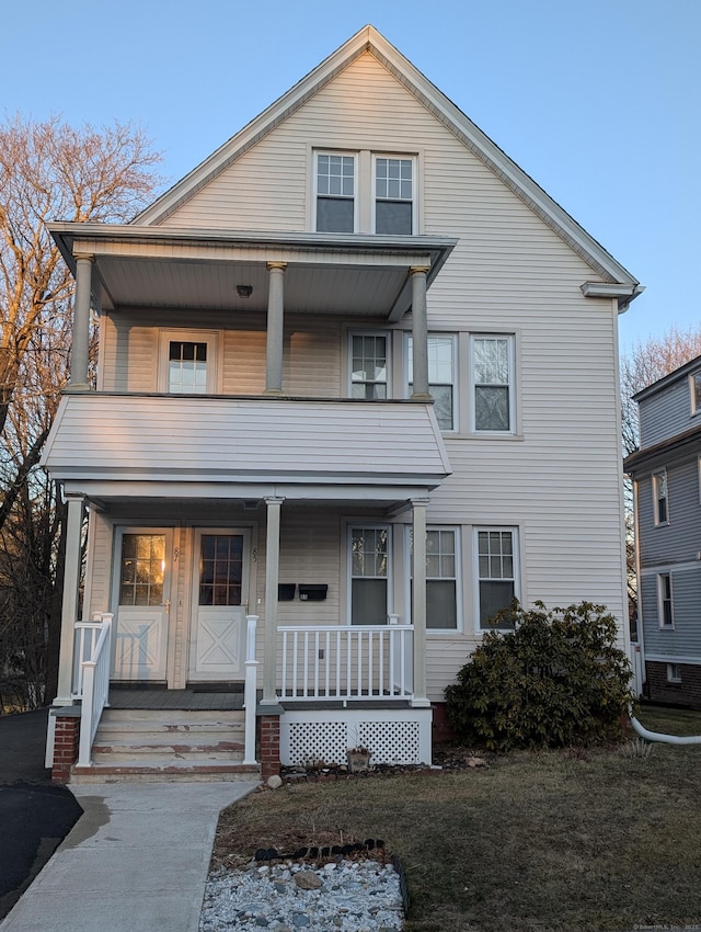 view of front of property with a porch and a balcony