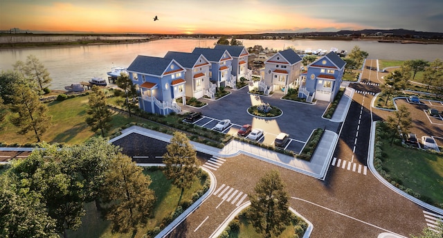 birds eye view of property with a water view and a residential view