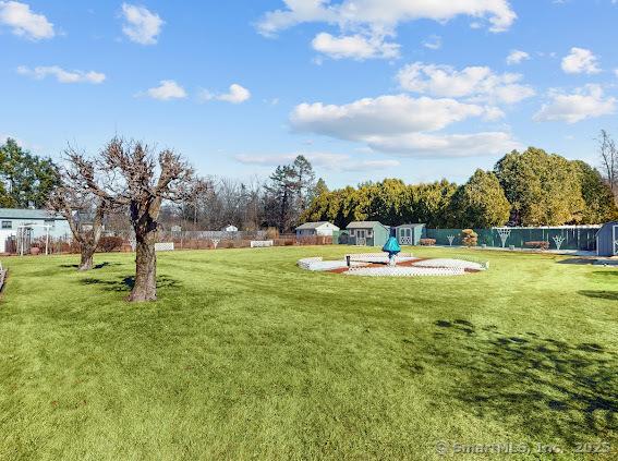 surrounding community with a yard and a fenced backyard