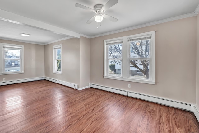 spare room featuring plenty of natural light, ornamental molding, wood finished floors, and a baseboard radiator