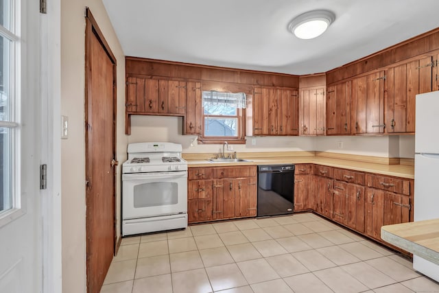 kitchen with brown cabinetry, white appliances, light countertops, and a sink