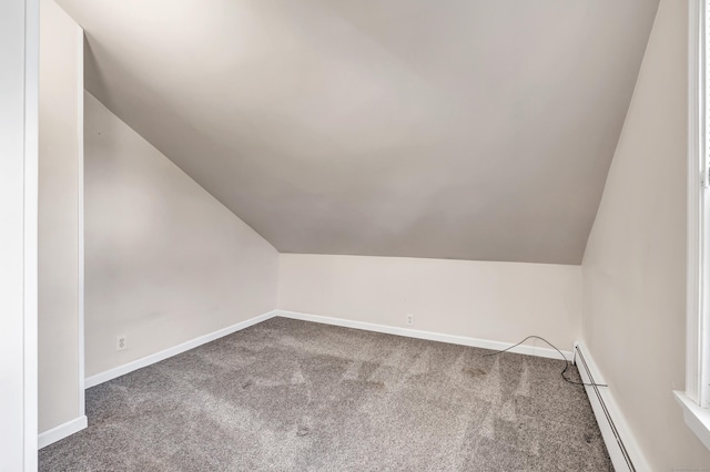 bonus room featuring baseboard heating, baseboards, carpet, and vaulted ceiling