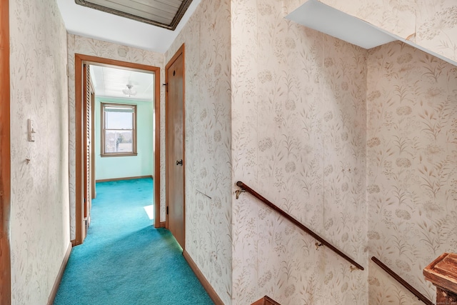 hall featuring baseboards, carpet, and wallpapered walls