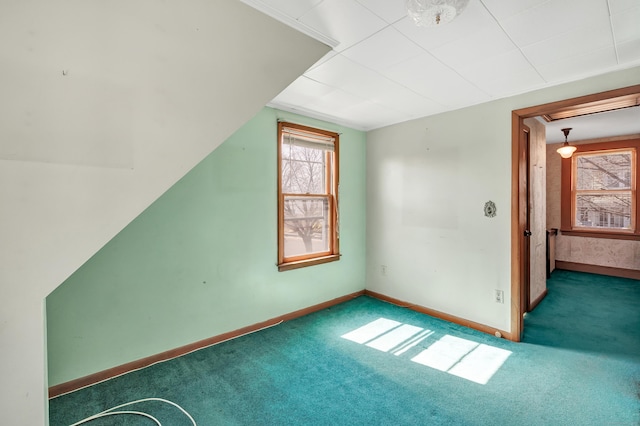 bonus room featuring carpet and baseboards