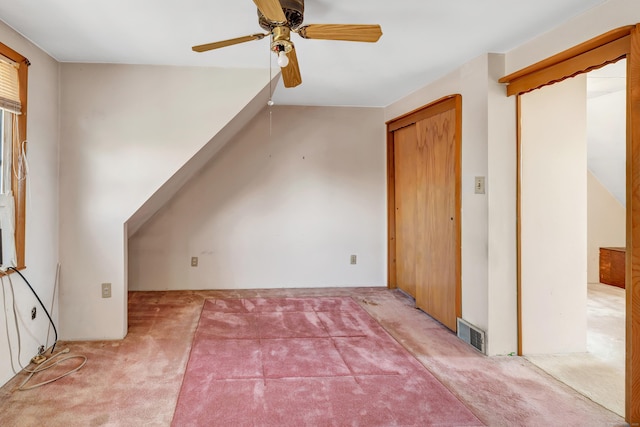 additional living space with carpet flooring, visible vents, and ceiling fan