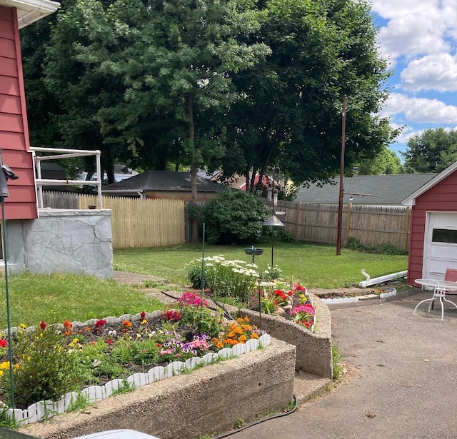 view of yard with a patio, a vegetable garden, and fence