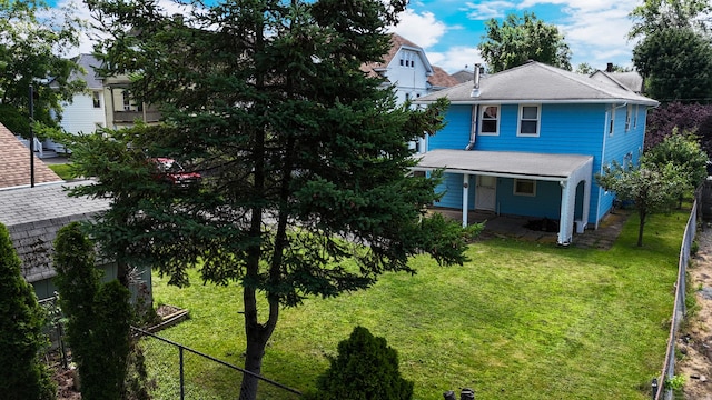 view of front of house featuring a lawn and fence