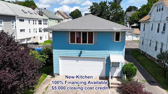 view of front of property with an attached garage and roof with shingles