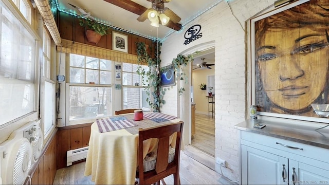 dining space with a baseboard radiator, plenty of natural light, and ceiling fan