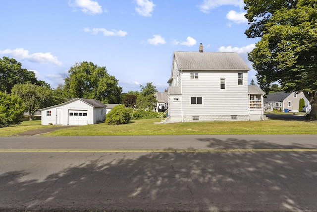 view of property exterior featuring an outbuilding, a lawn, a chimney, and a detached garage