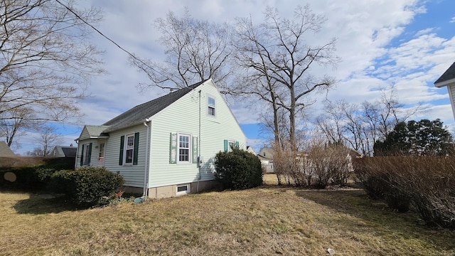 view of side of home with a yard