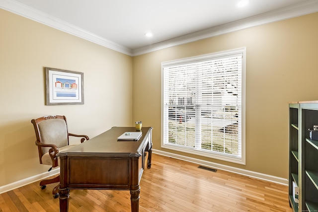 office featuring light wood-style flooring, visible vents, baseboards, and ornamental molding