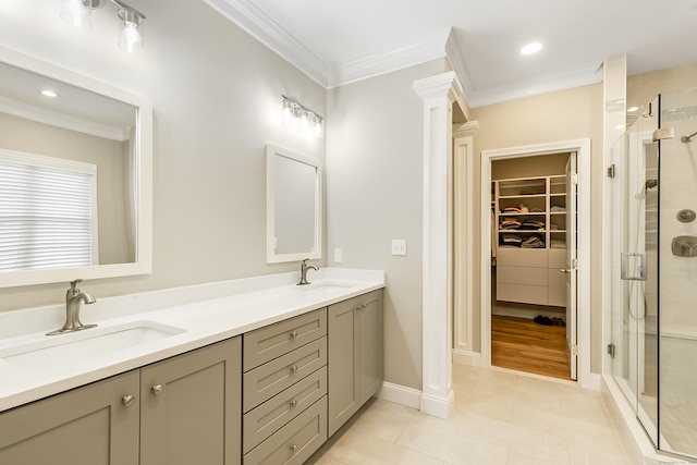 bathroom with a stall shower, ornamental molding, and a sink