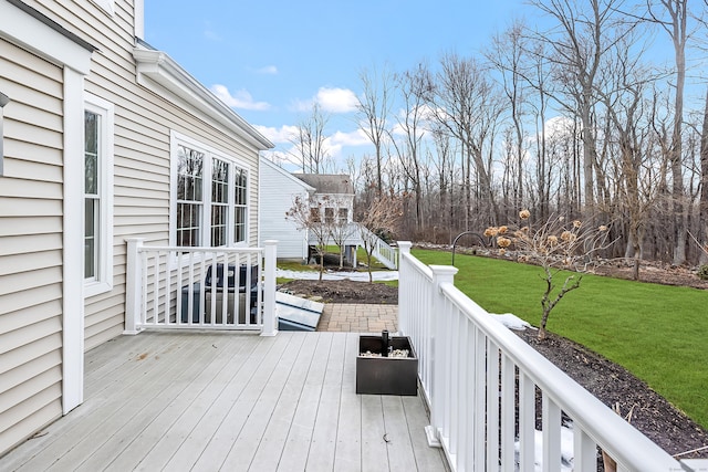 wooden terrace with a lawn