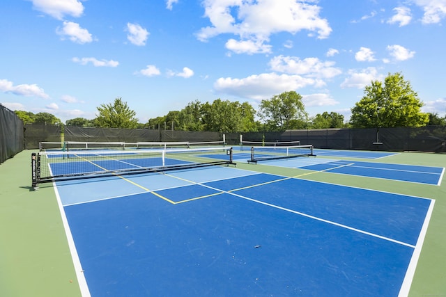 view of tennis court featuring fence