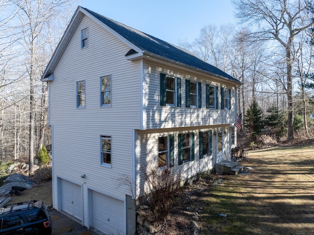 view of side of home with a garage