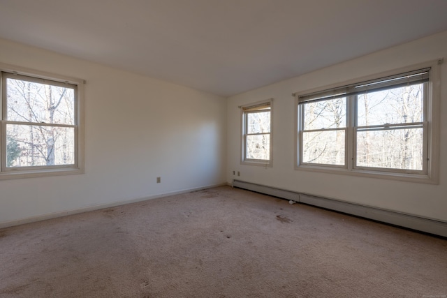 carpeted empty room with baseboards and a baseboard radiator