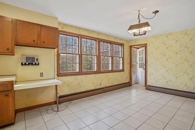 unfurnished dining area featuring wallpapered walls, light tile patterned floors, baseboards, and a baseboard radiator