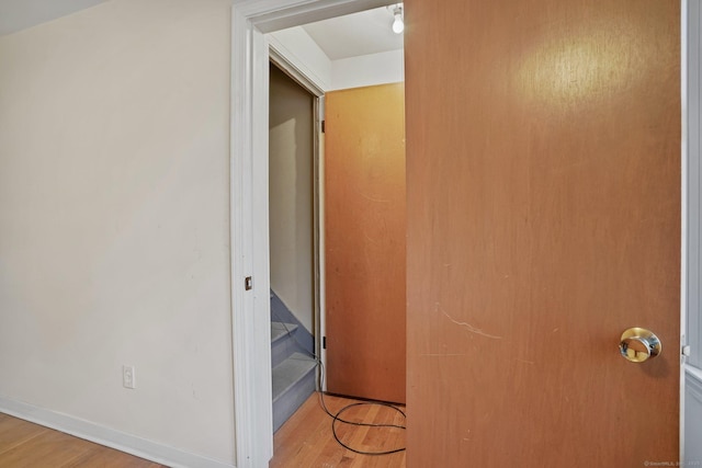 hallway with wood finished floors and baseboards