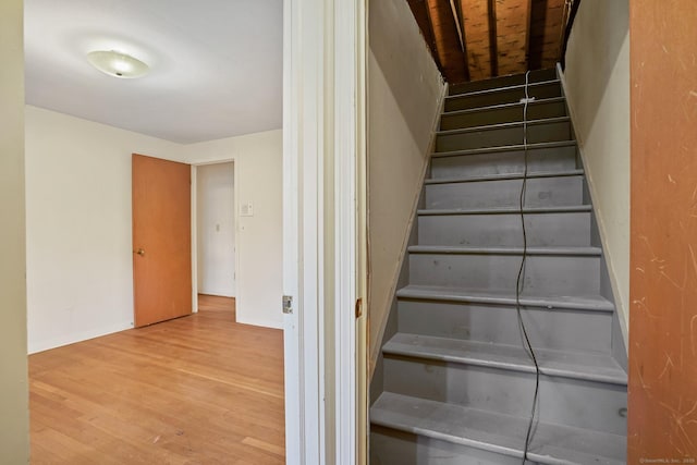 stairs with baseboards and wood finished floors