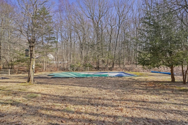 surrounding community with a pool and fence