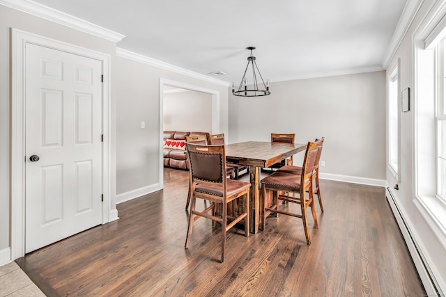 dining area with a baseboard heating unit, dark wood-style flooring, and crown molding