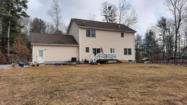 back of house featuring a wooden deck and a yard