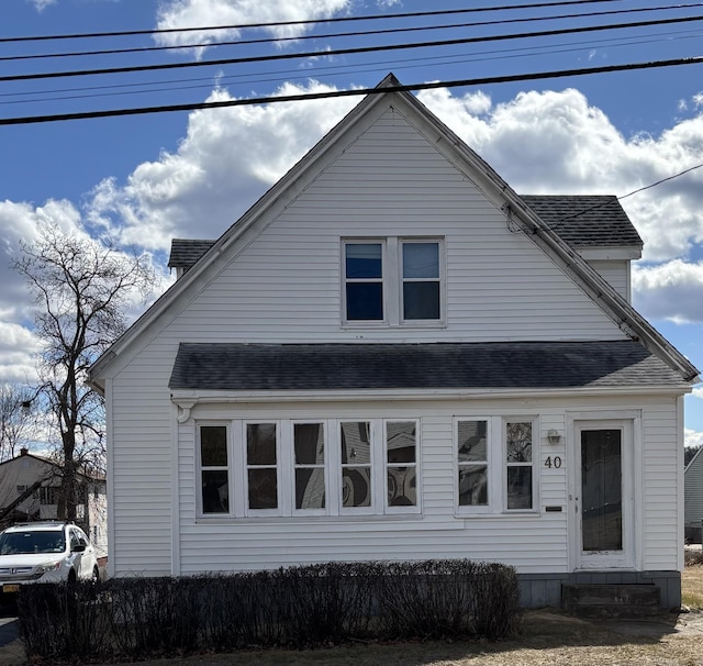 view of front of house featuring entry steps and roof with shingles