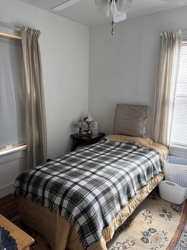 bedroom featuring wood finished floors and ceiling fan